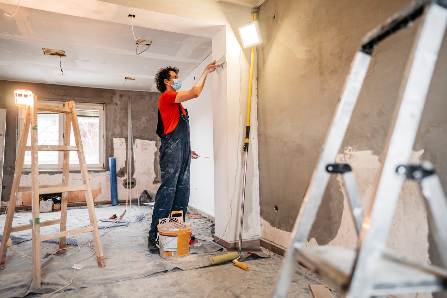 Construction worker plastering and smoothing concrete wall Construction worker plastering and smoothing concrete wall